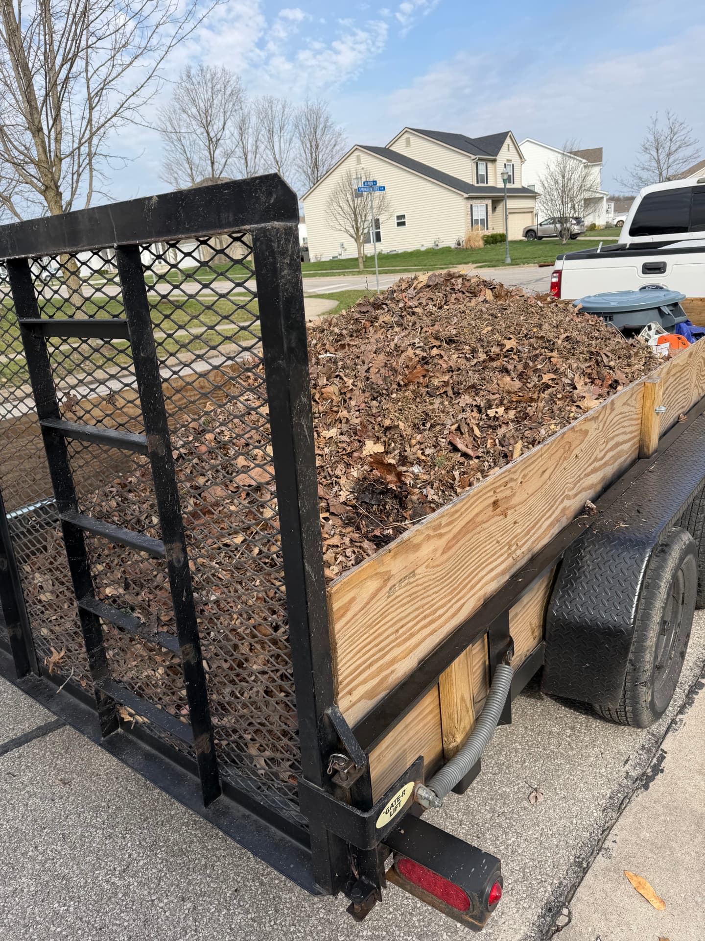 Trailer loaded with leaves and yard debris after a seasonal cleanup
